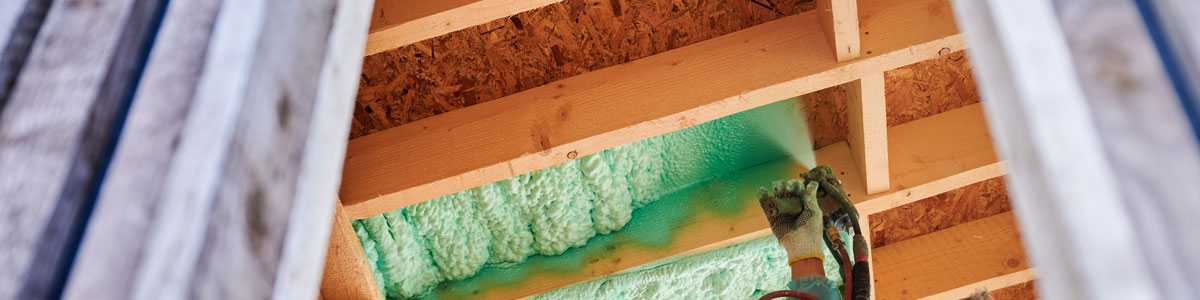 Worker Spraying Polyurethane Foam For Insulating Wooden Frame House.