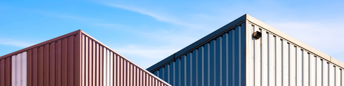 Low Angle View Of 2 Modern Brown And Silver Corrugated Steel Ind Low Angle View Of 2 Modern Brown And Silver Corrugated Steel Ind