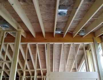 Open ceiling framing showing structural preparation for attic insulation and complete air sealing