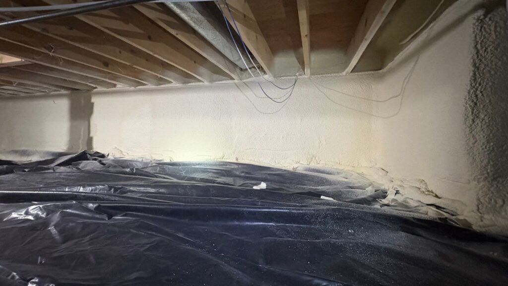Spray foam crawl space insulation with vapor barrier installed in Michigan home